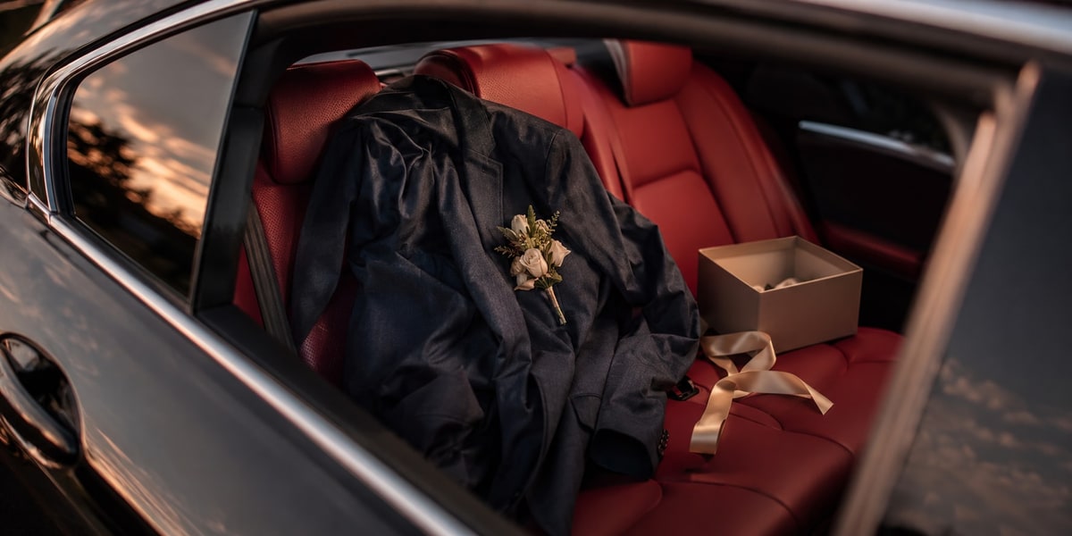 Close-up of a Toyota Camry XSE's black roofline and red interior accents, the car from the wedding story