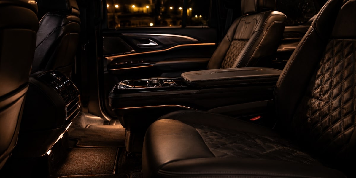 Couple arriving at a Houston event venue in a luxury rental SUV for a special occasion